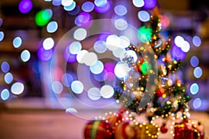 Lights and christmas tree on colorful defocused background