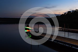 Lights on Fishermans Boat on Early Morning Lake