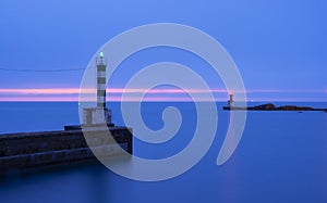 Lights at the harbor entrance, sea and blue sky at sunset, Pasaia