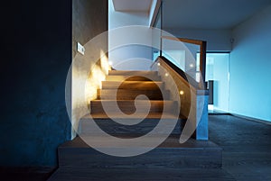 Lights illuminating the stairway in modern house interior photo