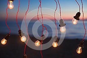 Lights and lights at night against the background of the ocean. Bokeh.