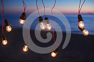 Lights and lights at night against the background of the ocean. Bokeh.