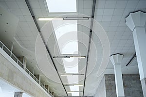 Lights in long line on ceiling of the office industrial building, exhibition hall