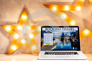 lights online booking and reservation. Search flights on a computer laptop screen, office desk background