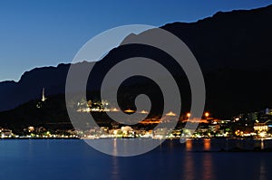 Lights of Podgora at night with Biokovo mountain