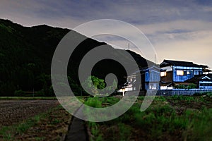 Lights on in rural Japanese farm house at night