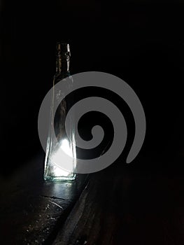 Lights seemingly eminating from an antique bottle