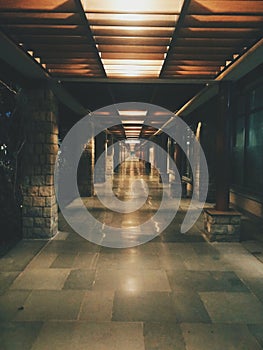 the lights shine brightly above a stone walkway at night in a subway station