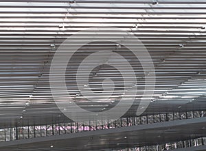 Lights and ventilation system in long line on ceiling of the industrial building. Exhibition Hall. Ceiling factory construction..