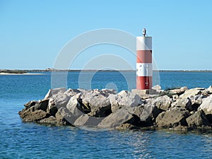 Lighttower and harbor entrance in Fuseta, Algarve - Portugal