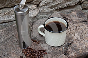 Lightweight coffee grinder for camping and the outdoor life with enamal coffee cup and beans