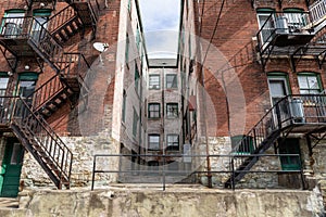 Lightwell within an old apartment building flanked by metal fire escapes