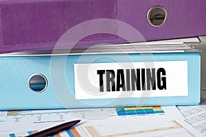 A lignt blue folder with the label TRAINING