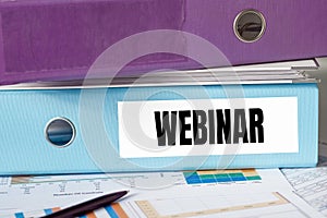 A lignt blue folder with the label WEBINAR