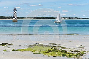 Ligthouse and boat near the ÃŽle-Tudy, bright summer day