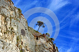 Liguria: view from the cliff island of Palmaria island with rocks trees sky and clouds