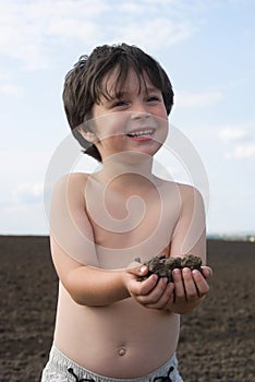 The liitle boy with black earth