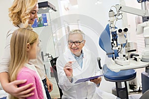 Likable eye specialist gives eye glasses to child