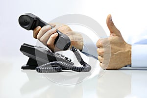 Like hand with office phone on desk