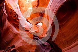 Like a large open mouth and an empty eye socket in the mysterious Lower Antelope Canyon in Page Arizona with natural landscapes of