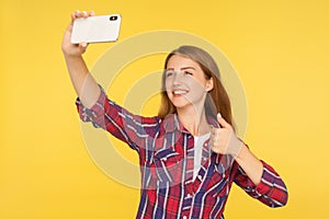 Like! Portrait of happy blogger, ginger girl in casual shirt making video call or online streaming using mobile phone