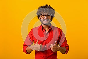 Like. Portrait of optimistic handsome brunette man with beard showing thumbs up gesture and smiling, meaning well done