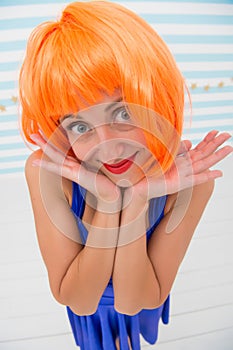 She likes bright outfit. Lady actress practicing performance. Girl posing striped background of studio. Lady red ginger