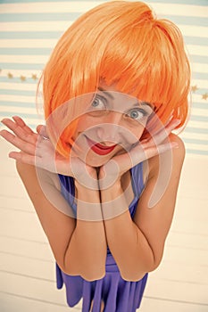 She likes bright outfit. Lady actress practicing performance. Girl posing striped background of studio. Lady red ginger