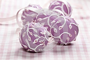 Lilac cake pops lavishly decorated with icing.