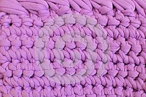 Lilac crocheted texture made of knitted cotton yarn. Lilac handmade background - crafts and hobby