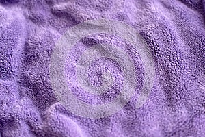 Lilac delicate soft background of fur plush smooth fabric. Texture of purple soft fleecy blanket textile