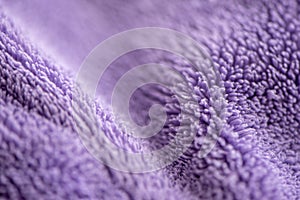 Lilac delicate soft background of fur plush smooth fabric. Texture of purple soft fleecy blanket textile