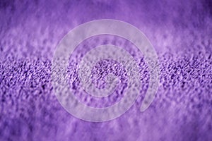 Lilac delicate soft background of fur plush smooth fabric. Texture of purple soft fleecy blanket textile