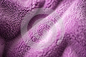 Lilac delicate soft background of fur plush smooth fabric. Texture of purple soft fleecy blanket textile