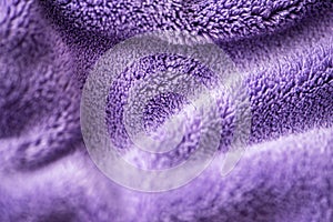 Lilac delicate soft background of fur plush smooth fabric. Texture of purple soft fleecy blanket textile