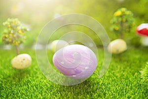 Lilac easter egg on green grass in Dreamland