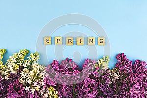 Lilac flower blooming background. Spring wooden lettres text, concept clipart. Closeup floral frame photo