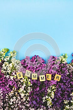 Lilac flower blooming background. Summer wooden lettres text, concept clipart. Closeup floral frame photo