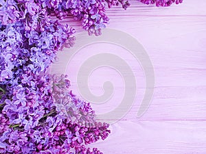 Lilac flower bouquet design decor on pink wooden background frame photo