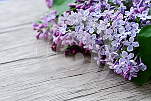 Lilac flower bouquet on wooden background