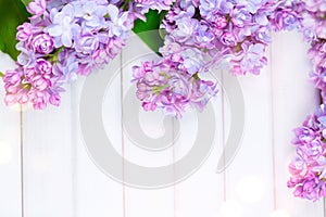 Lilac flowers bunch on white planks wood background