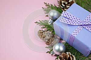 Lilac gift with polka dot ribbon on pink