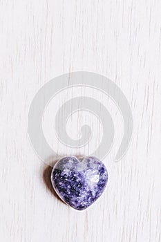 Lilac lepidolite stone heart on white background