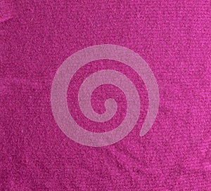 Lilac-pink knitted carpet close-up. Textile texture on a lilac-pink background. Detailed warm yarn background. Natural wool fabric