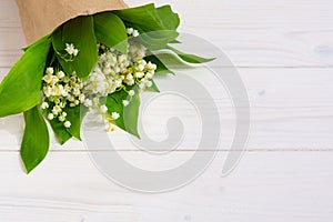 Lilies of the valley on a white wooden background