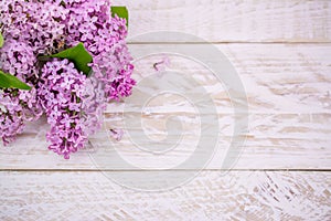 Lillac flowers on wooden background