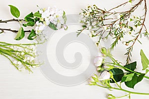Lilly of the valley, apple tree twigs, chamelaucium and roses