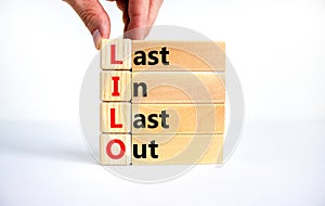 LILO last in last out symbol. Concept words LILO last in last out on wooden blocks. Beautiful white table white background.