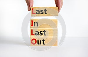 LILO last in last out symbol. Concept words LILO last in last out on wooden blocks. Beautiful white table white background.