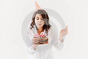 a lilt woman with a birthday cake with candles.